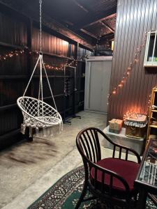 a room with a swing and a table and chairs at 多賀三宿 in Taga