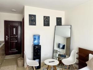 a room with a mirror and a blue vase on the wall at Cozy Studio Apartment in Nairobi West in Nairobi