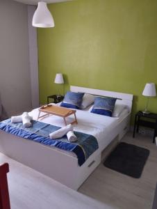 a bedroom with a large bed with blue and green walls at Quartier Saint Jacques - Maison 5 chambres in Brest +69 photos