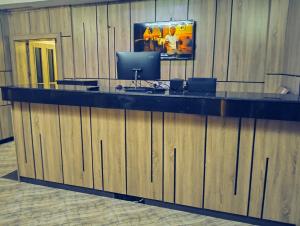 a lobby with a large counter with a television on it at Thirdland view hotel and suites in Oko Anala
