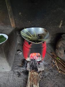 a potted plant in a red pot with a bowl at Casa Matā Phitā Cottage in Patjung