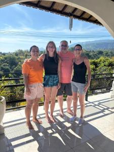 a group of people posing for a picture on a balcony at Villa Jambu, lovina-kayuputih in Lovina