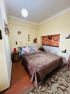 a bedroom with a large bed and a brick wall at Lovely Goris in Goris +37 photos