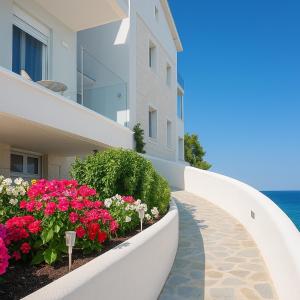 a walkway in front of a building with flowers at Gloria Luxury Suites in Kallithea Halkidikis