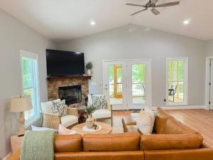 a living room with a couch and a fireplace at Stylish Lake Getaway: Kayaks •Foosball •Ping Pong in Badin