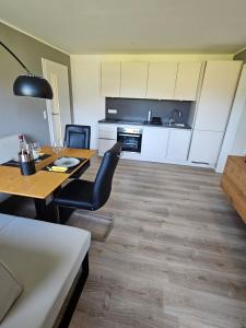 a kitchen and dining room with a table and chairs at Appartment Haus Einbergblick in Abtenau
