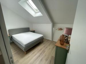 a small bedroom with a bed and a desk at Comme à la maison in Grand-Fougeray