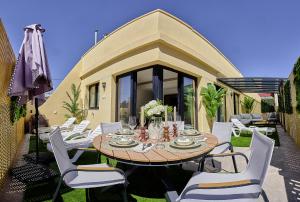 a dining table and chairs on a patio at La huerta centro in Alicante