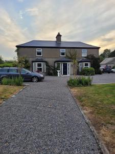 a house with cars parked in front of it at Rolestown Farm in Swords