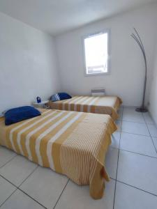 En eller flere senge i et værelse på Maison au bord de mer