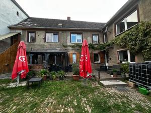 two red umbrellas in the yard of a house at Himmelsscheibe in Wangen