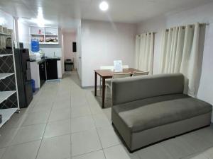 a living room with a couch and a table at Abode86 Transient-Agus in Lapu Lapu City