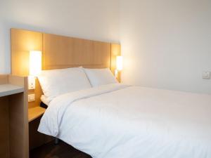 a large white bed in a hotel room at B&B HOTEL Kielce Centrum in Kielce +16 photos