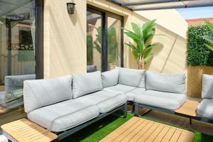 a white couch sitting on a patio at La huerta centro in Alicante
