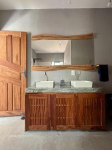 a kitchen with two sinks and a counter top at Barra Beach House in Fortim