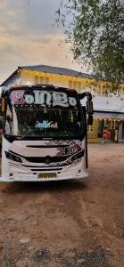 a white bus parked in front of a building at Le paradiso in Marayoor +3 photos