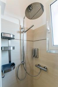 a shower with a shower head in a bathroom at Padova Relax Station in Padova