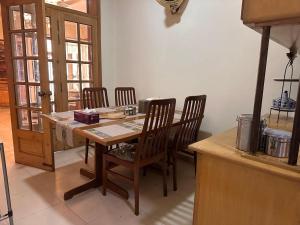 a wooden table and chairs in a kitchen at Zaxis Suite&Lounge in Rawalpindi