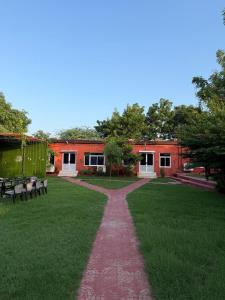a walkway in front of a building with benches at Casa Chillax in Jodhpur