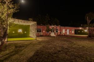 a house with a green wall in the yard at night at Casa Chillax in Jodhpur +3 photos