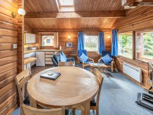 a dining room with a table and chairs in a cabin at Cardhu Lodge - Uk49120 in Feshiebridge