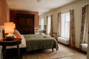 ein Schlafzimmer mit einem Bett und einer Lampe auf einem Tisch in der Unterkunft Landgoed Frymerson in Sint Odiliënberg