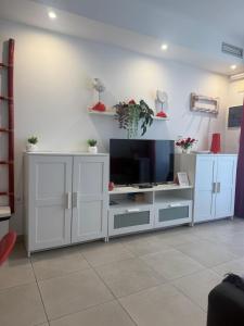 a living room with a tv and white cabinets at Corralejo Sun 202 in Corralejo