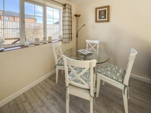 a dining room with a glass table and two chairs at Cherry - Uk49174 in Burgh le Marsh