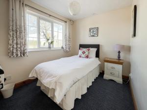 a bedroom with a bed and a window at Cherry - Uk49174 in Burgh le Marsh