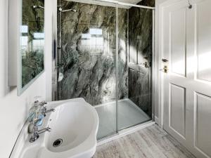 a bathroom with a shower and a sink and a tub at Cherry - Uk49174 in Burgh le Marsh +2 photos