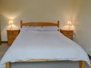 a bedroom with a large bed with two night stands at Stable Cottage 5 - Ukc3744 in Bawdeswell
