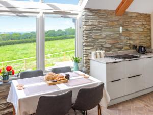 a kitchen with a table with a plate of food on it at Y Felin in Llandissilio +14 photos