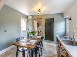 a kitchen with a table with chairs and a sink at Willoways in Bakewell