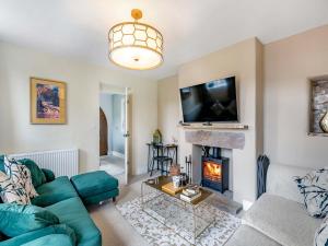 a living room with a couch and a fireplace at Willoways in Bakewell