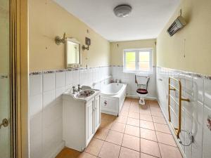 a bathroom with a tub and a sink and a toilet at Violet Bank in Cockermouth +4 photos