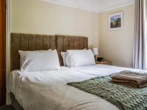 a bedroom with a large bed with white sheets and pillows at 2 Le Dorney Villa - Uk49804 in Par