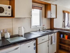 a kitchen with a sink and a counter top at Waterlily in Lancaster