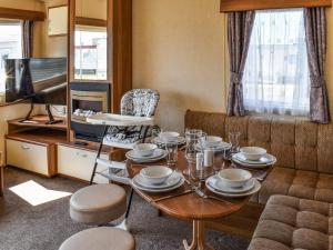 a living room with a table and a couch at Waterlily in Lancaster