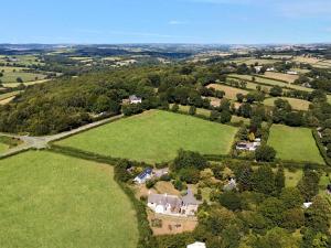 an aerial view of an estate with a large green field at The Coach House - Uk49601 in Lifton