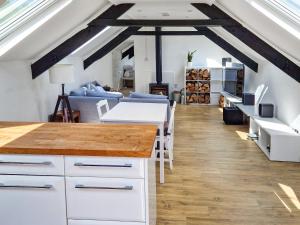 a kitchen and living room with a loft at The Coach House - Uk49601 in Lifton
