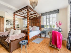 a bedroom with a large canopy bed and a couch at The Old School in Ganton