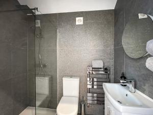 a bathroom with a toilet and a sink and a mirror at Garden Cottage in Thornton Dale +8 photos