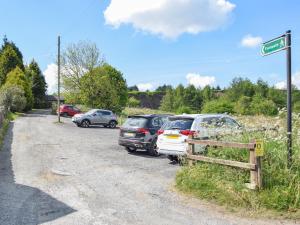 a group of cars parked on the side of a road at Doorstones Cottage in Moorside