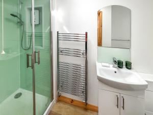 a bathroom with a sink and a glass shower at Parade - Uk49713 in Greatstone