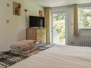 a bedroom with a bed with a flat screen tv at 2 Le Dorney Villa - Uk49804 in Par