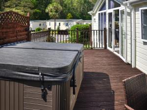 a porch with a mattress on a deck at Holly Lodge in Ilfracombe