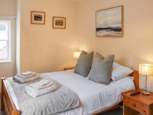 a bedroom with two beds with towels on them at Ty Llewelyn in Conwy