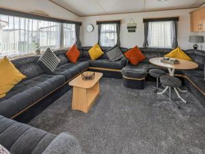 a living room with a couch and a table at Amanda in Kinmel Bay