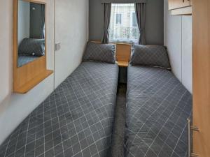 a small room with a bed in a train at Amanda in Kinmel Bay