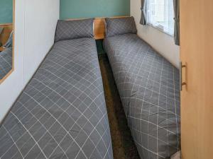 a bed in the corner of a room at Amanda in Kinmel Bay +3 photos